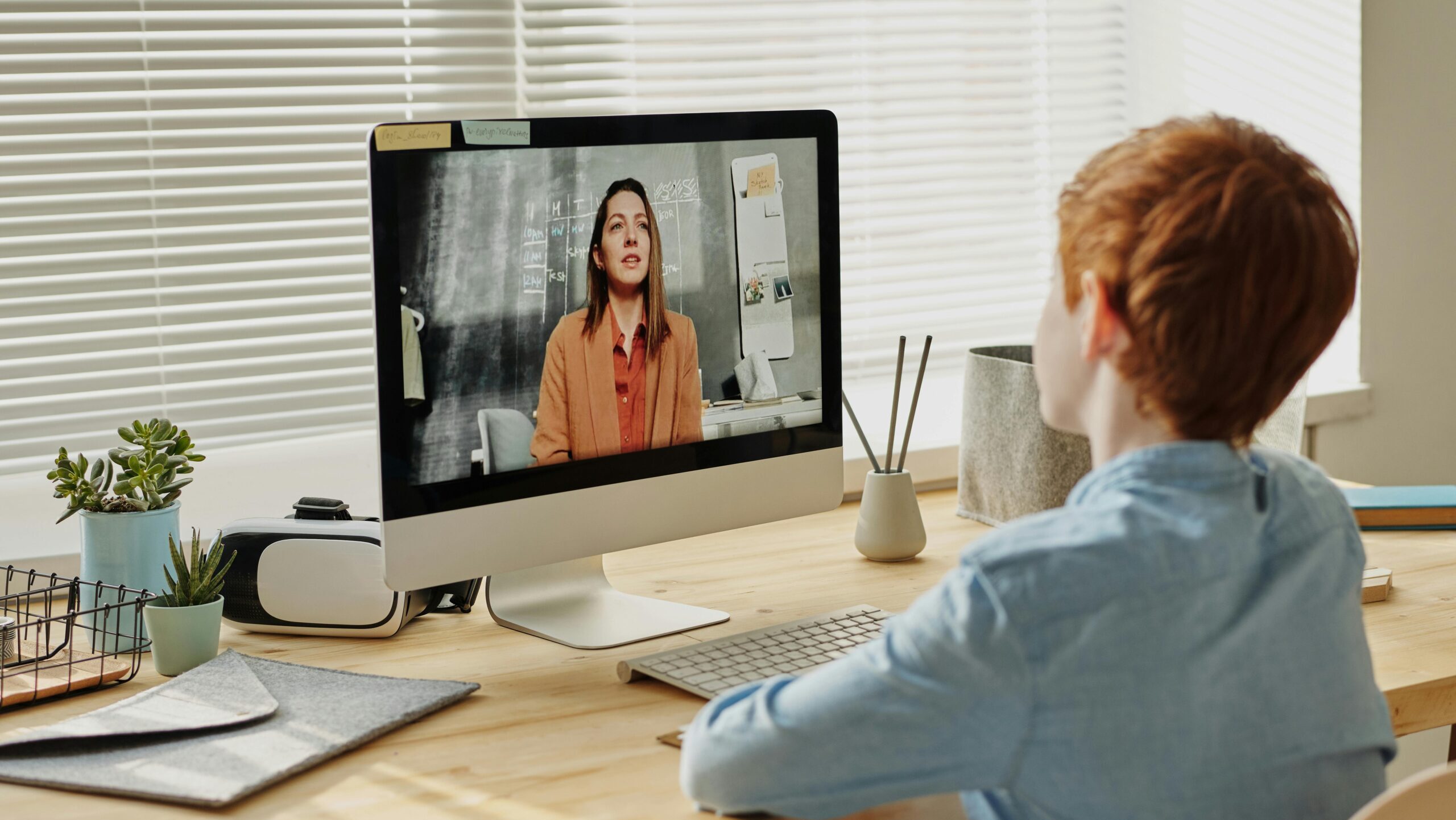 Child attending an online class at home via computer, enhancing remote education.